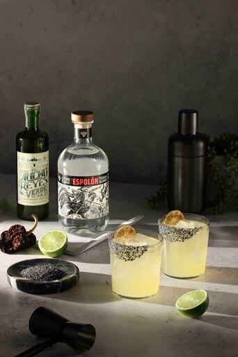 a classic margarita with a rich black salt on a brightly lit stage